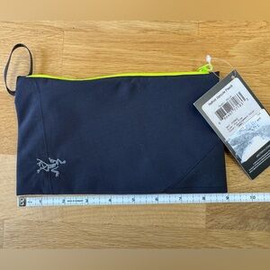 Black Arc’teryx Rebird pouch with neon green zipper